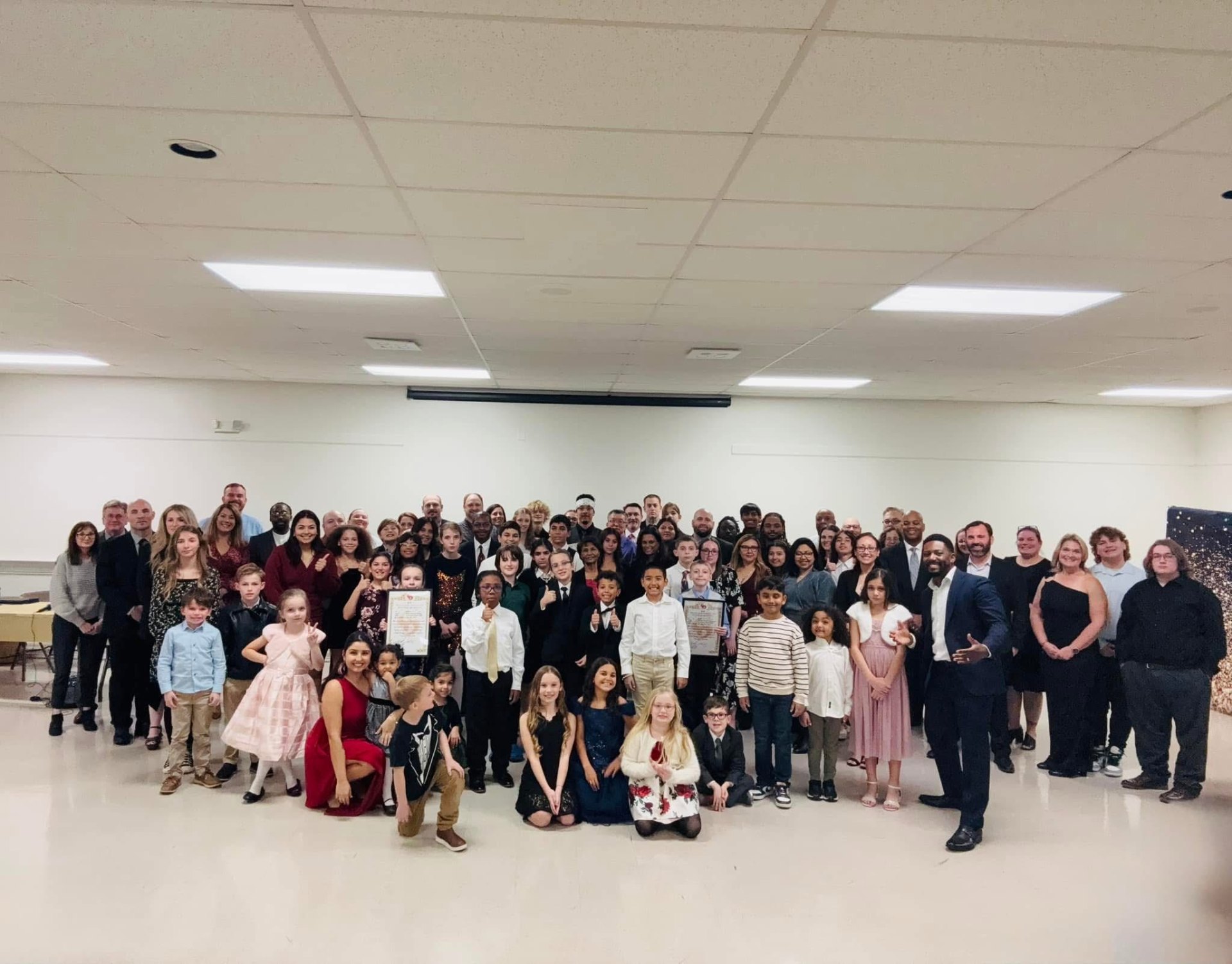 Justin Ladson with families and the Teen Success Mentorship community at a celebration